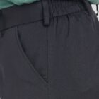 Close-up of black pants with an elastic waistband and side pocket.