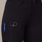 Person wearing black cargo pants with scissors and a pen in the side pocket.