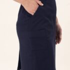 Person wearing a navy knee-length cargo skirt with hands in pockets.