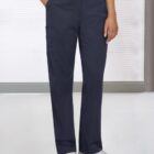 Person wearing dark blue cargo pants and white sneakers stands in a light room.