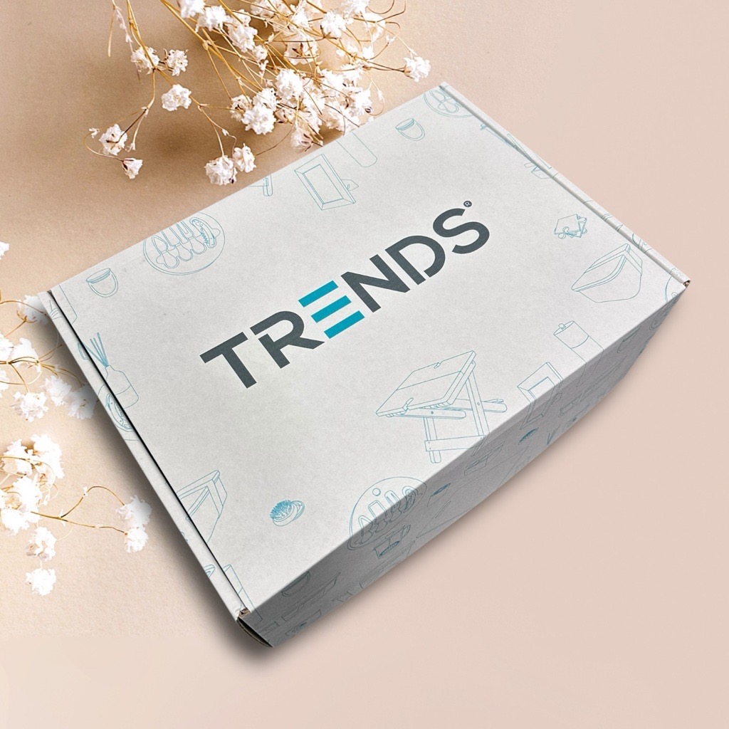 Gift box labeled TRENDS adorned with floral designs on a beige backdrop.
