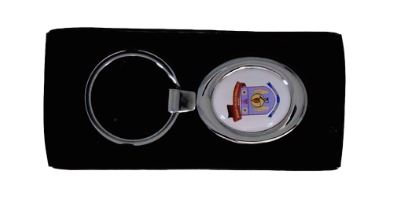 Silver personalised keychain with a colorful crest emblem, in a black presentation box.