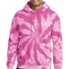 Smiling man wearing a pink tie-dye hoodie and jeans.