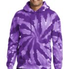Smiling person wearing a purple tie-dye hoodie and jeans.
