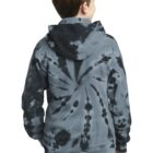 Boy wearing a tie-dye hoodie with spiral design, looking to the side.