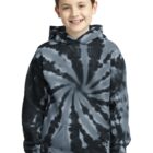 Smiling boy in a blue tie-dye hoodie stands against a white background.