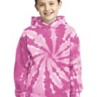 Boy wearing a pink tie-dye hoodie and jeans, smiling at the camera.