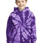 Child wearing a purple tie-dye hoodie and jeans, smiling.
