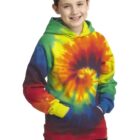 Child in colorful tie-dye hoodie smiles with hands in pockets.
