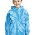 Smiling boy wearing a blue tie-dye hoodie and jeans.