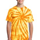Smiling person wearing an orange spiral tie-dye shirt and jeans.