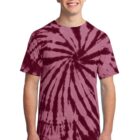 Smiling person wearing a red tie-dye T-shirt and jeans.