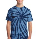 Smiling person in a blue tie-dye shirt and jeans against a white background.