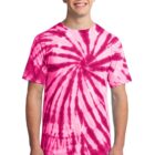 Man in a pink tie-dye T-shirt smiling against a white background.