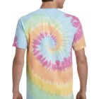 Man wearing a colorful spiral tie-dye T-shirt, standing with his back facing the camera.