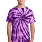 Person wearing a purple tie-dye shirt with a spiral pattern, smiling.
