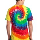 Person facing away, wearing a colorful tie-dye t-shirt and dark jeans.