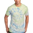 Man wearing a tie-dye shirt with green, blue, and white patterns, hands in pockets.