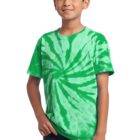 Child in green tie-dye shirt, smiling with hands in pockets.