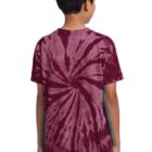 Boy in a red tie-dye shirt with spiral pattern, standing and facing away.
