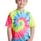 Smiling child in a colorful tie-dye shirt and jeans against a white background.