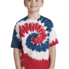 Child wearing a red, white, and blue tie-dye shirt, smiling at the camera.