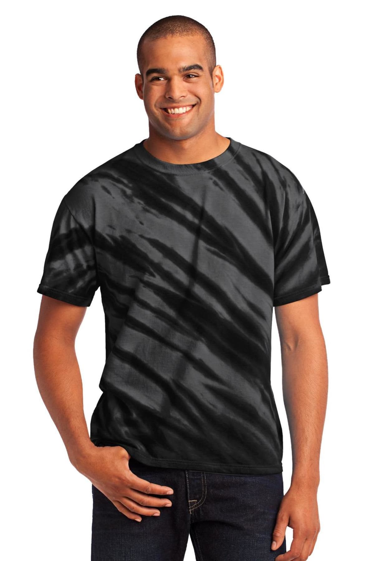 Man wearing a black tie-dye T-shirt, smiling with hands in pocket.