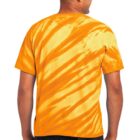 Man wearing an orange tie-dye shirt and jeans, viewed from the back.