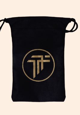 Black gift bag with a gold geometric logo on the front.
