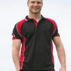 Person smiling, wearing a black and red polo shirt, standing outdoors.