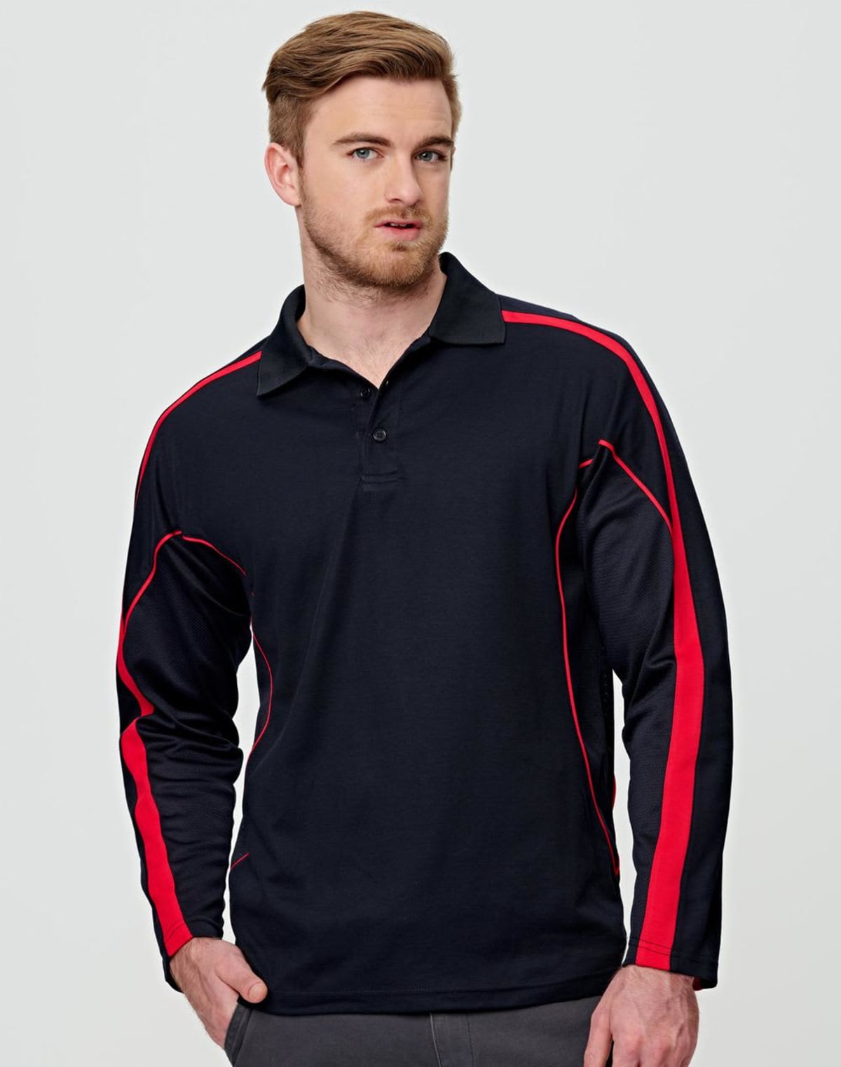Man in black and red long-sleeve polo shirt poses against a plain background.