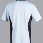 Back of a light blue polo shirt with black side panels on a gray background.