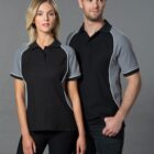 Two people wearing black and gray collared shirts pose against a gray background.
