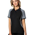 Woman in black and gray polo shirt, standing against a white background.