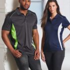 Two people wearing sporty polo shirts, one in grey and green, the other in navy and white.