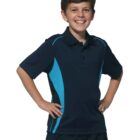 Smiling boy in a navy and blue polo shirt with hands on hips.
