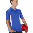 Young boy in blue shirt holding a red football, smiling and looking to the side.