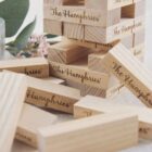 Wooden Jenga blocks stacked and scattered, engraved with The Humphries.