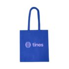 Blue tote bag with the Tines logo and name printed in light pink on the front.