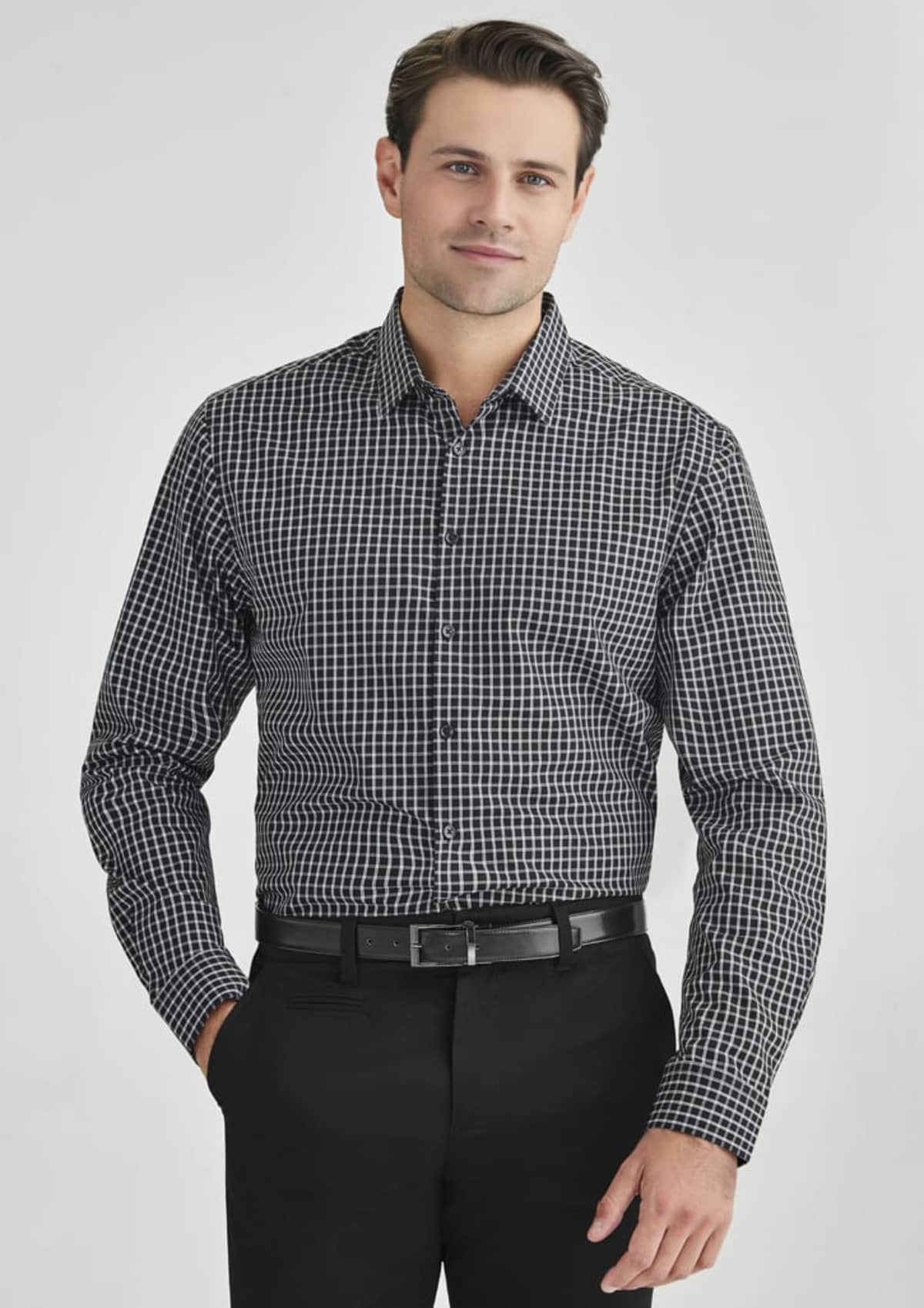 Person wearing a black and white checkered shirt and black pants against a white background.
