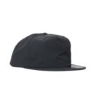Black flat-brim baseball cap on a white background, viewed from the side.