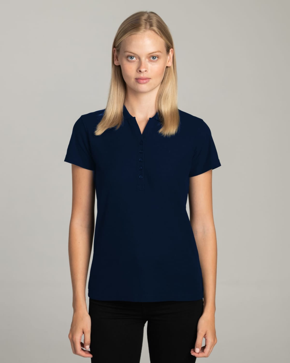 Woman wearing a short-sleeve navy shirt, standing against a plain light background.