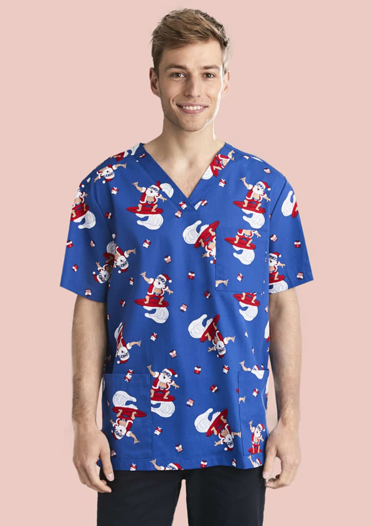 Person smiling, wearing a blue scrub top with Santa Claus print on a pink background.