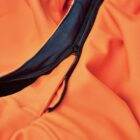 Close-up of an orange jacket with a partially open black zipper.