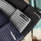 Ribbed beanies in black, gray, and navy with Streetbox label on wood surface.