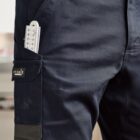 Close-up of navy work pants with a ruler in the side pocket.