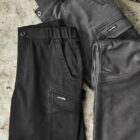 Black and gray cargo shorts lying on a textured surface.