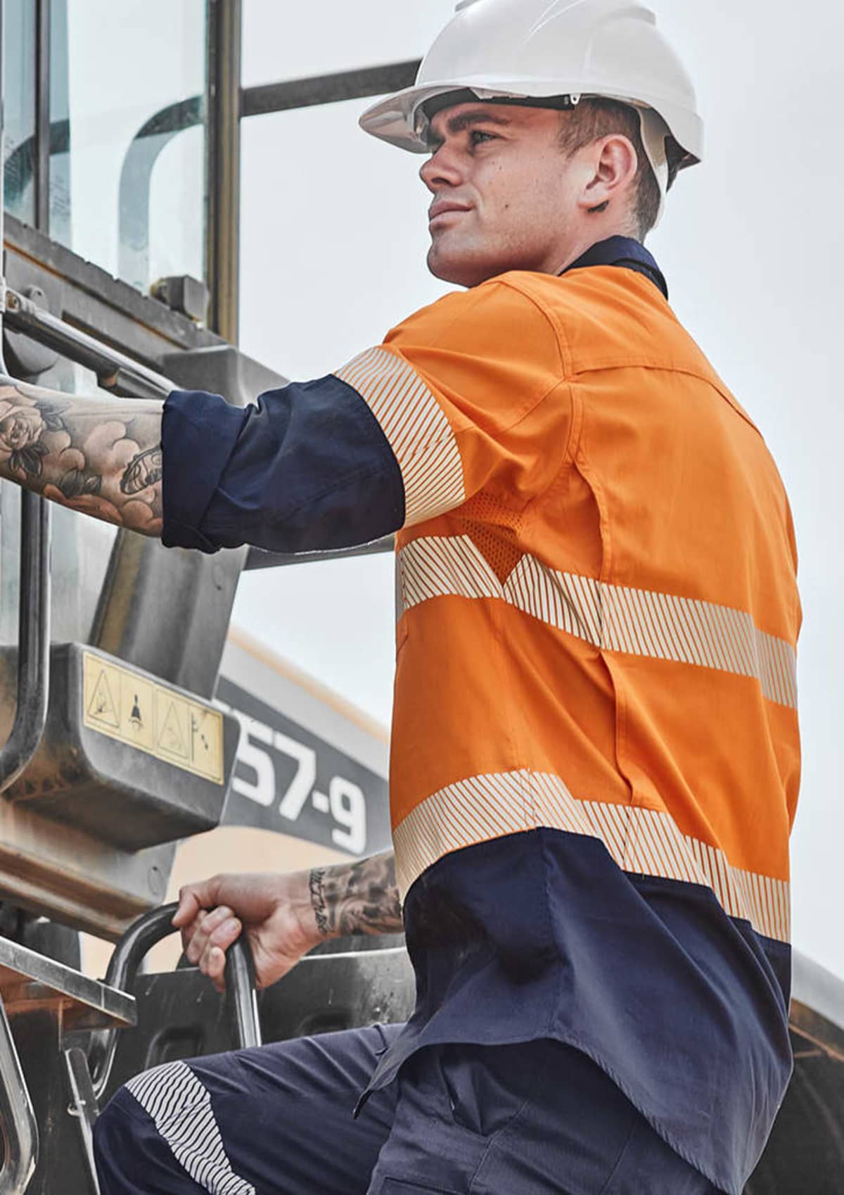 Person in safety gear operating construction machinery.