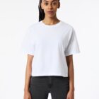 Person wearing a plain white t-shirt and black jeans, standing against a white background.