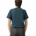 Person wearing a dark green cropped t-shirt and black jeans, shown from the back.